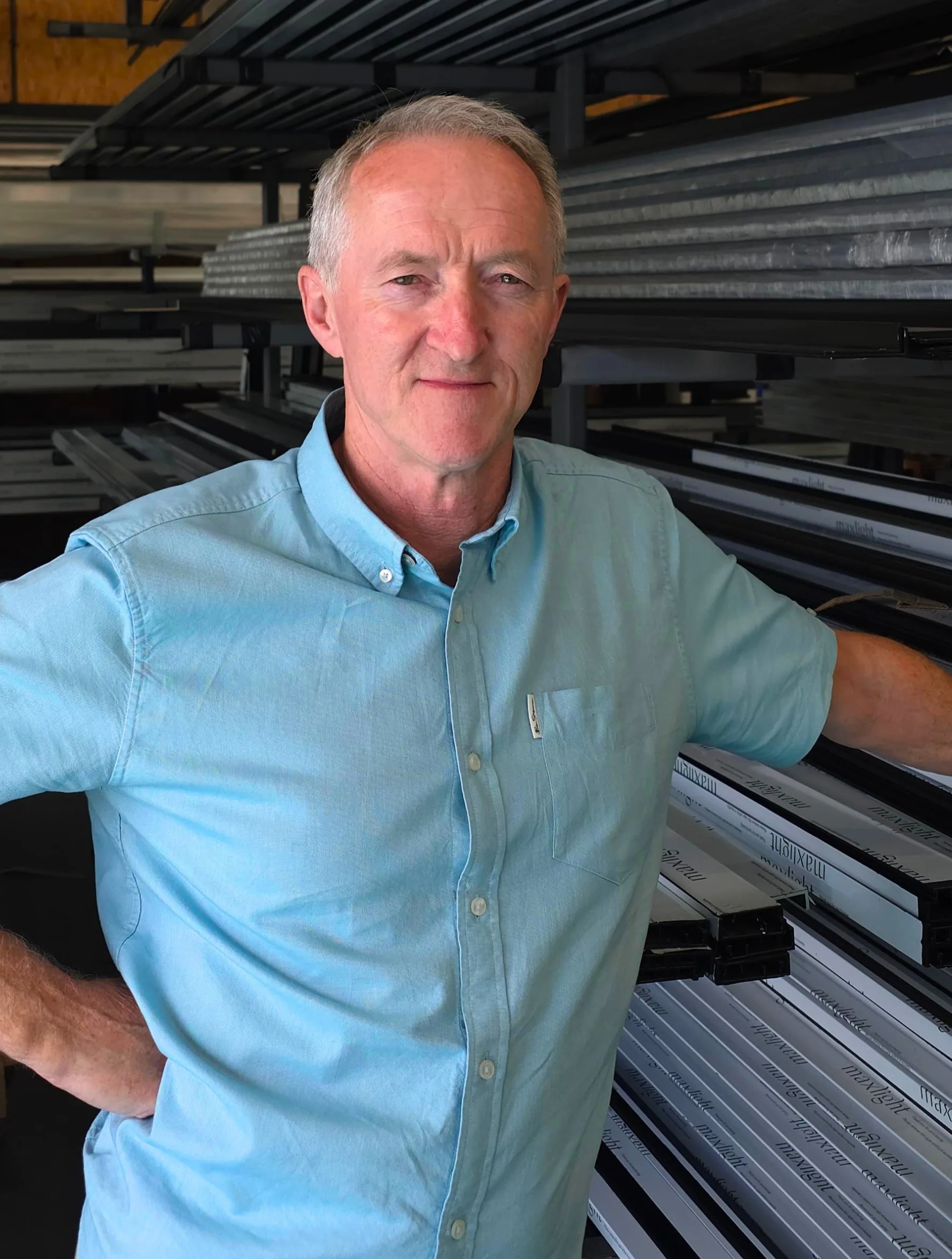 Tony Culmer, founder of Maxlight, among aluminium profiles