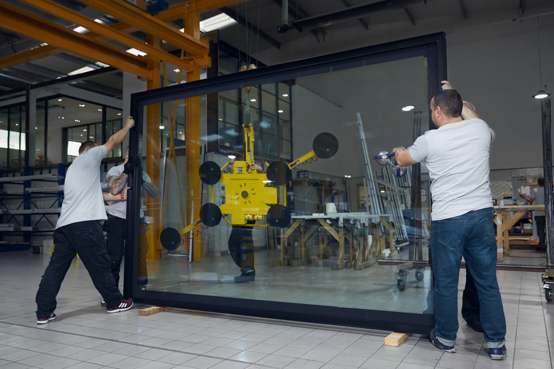 Maxlight workshop team handling a large glazed frame
