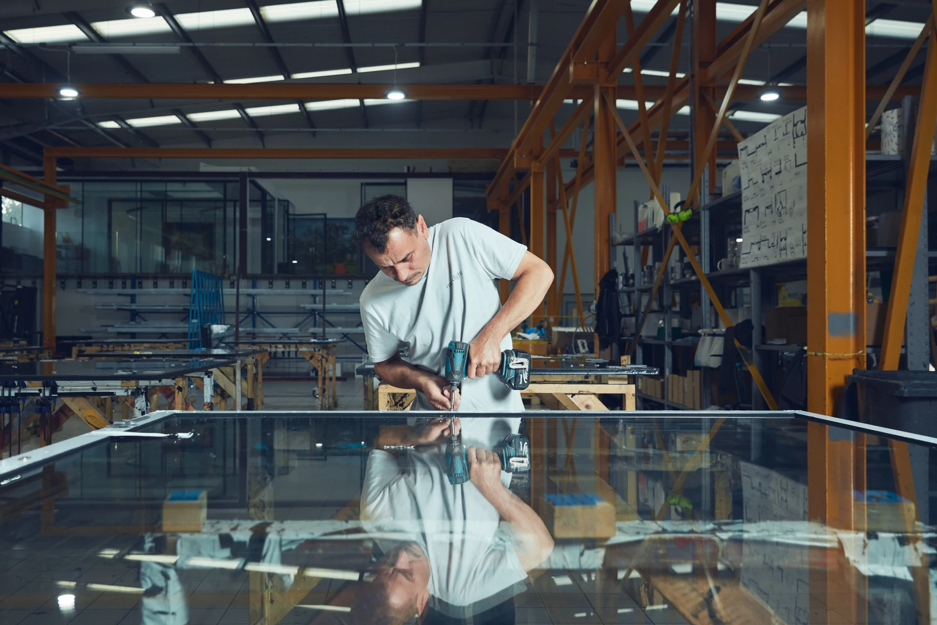 Maxlight technician working on architectural glass in the Acton manufacturing facility
