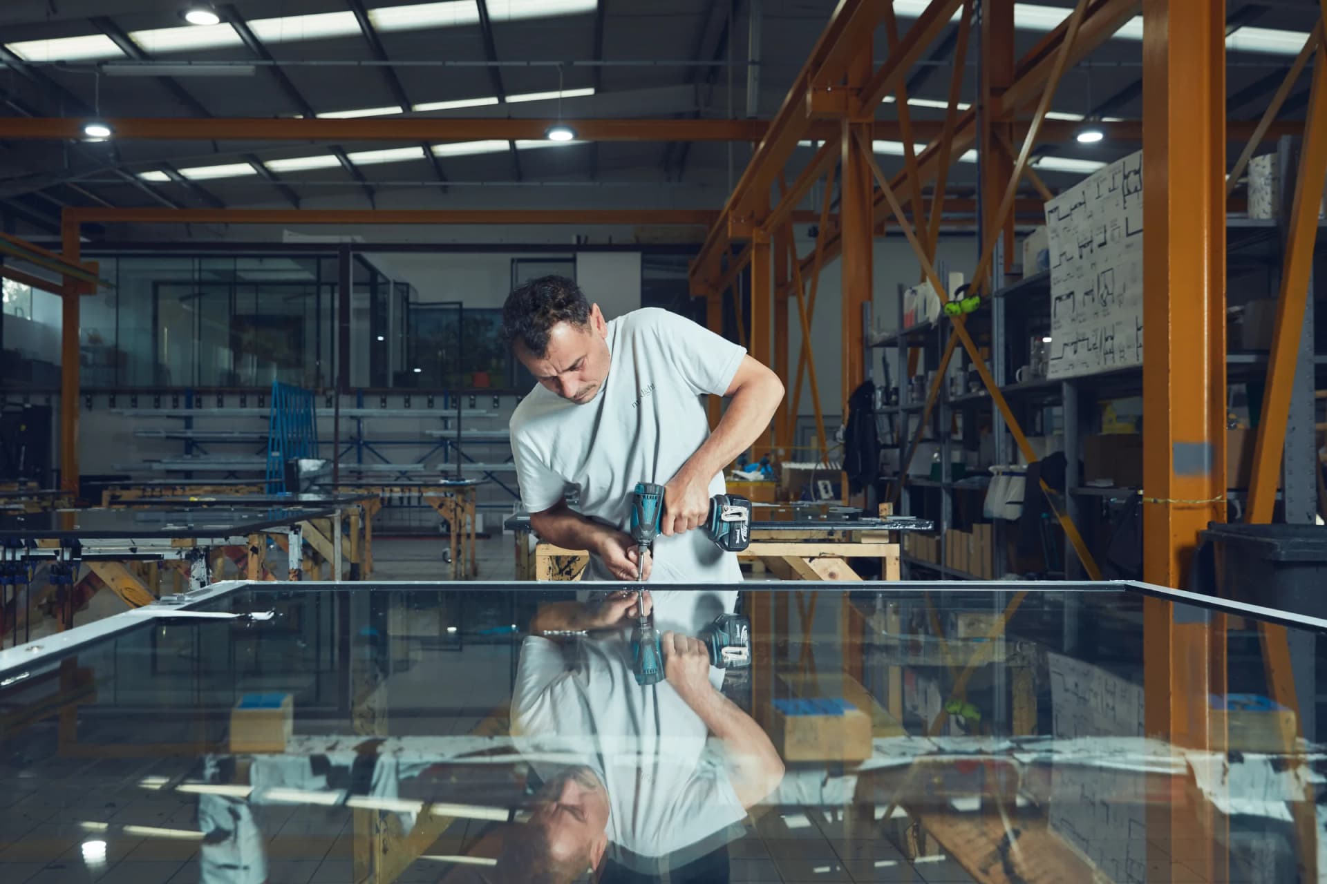 Maxlight technician working on architectural glass in the Acton manufacturing facility