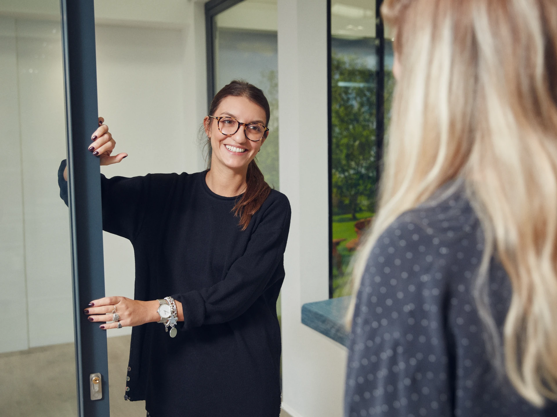 Maxlight team member discussing an initial glazing enquiry at a project doorway
