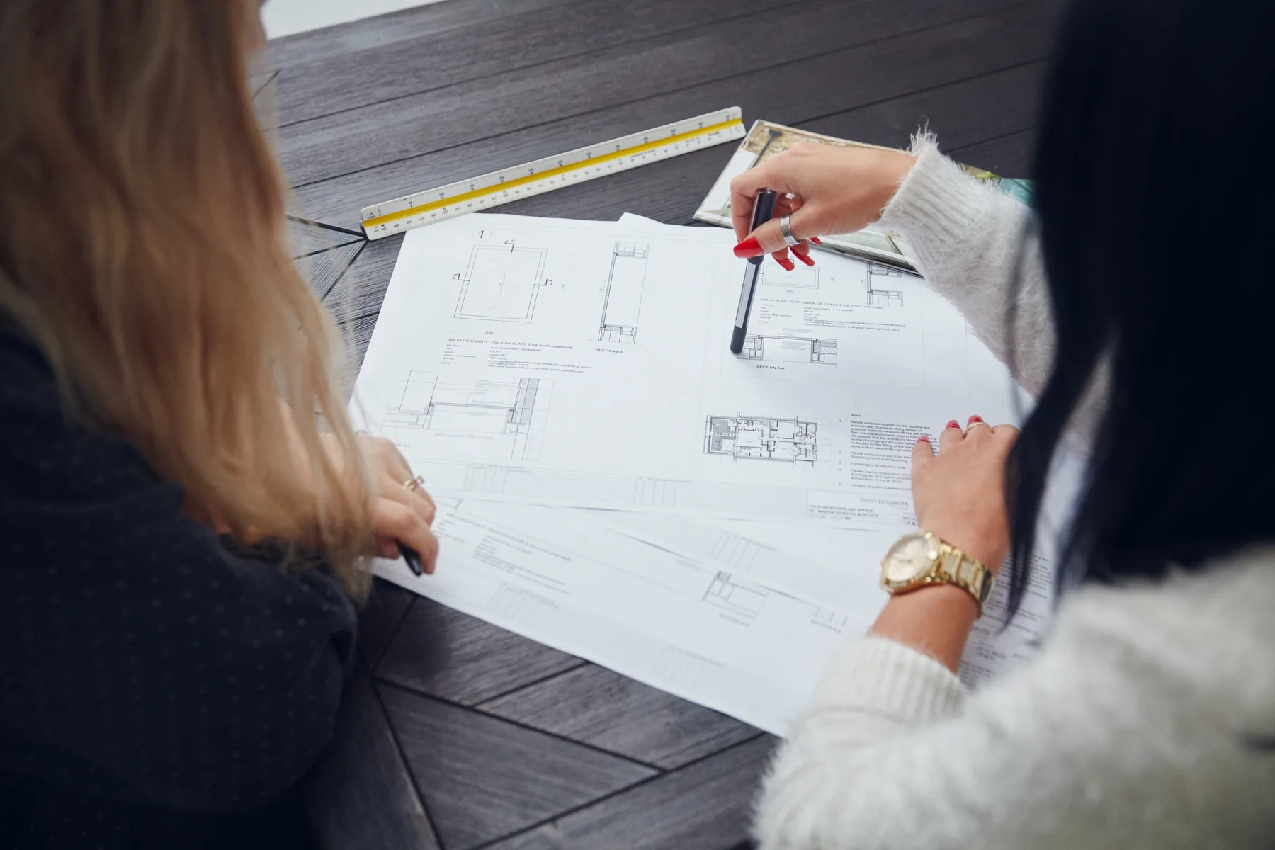 Maxlight team reviewing architectural drawings while preparing a glazing quotation