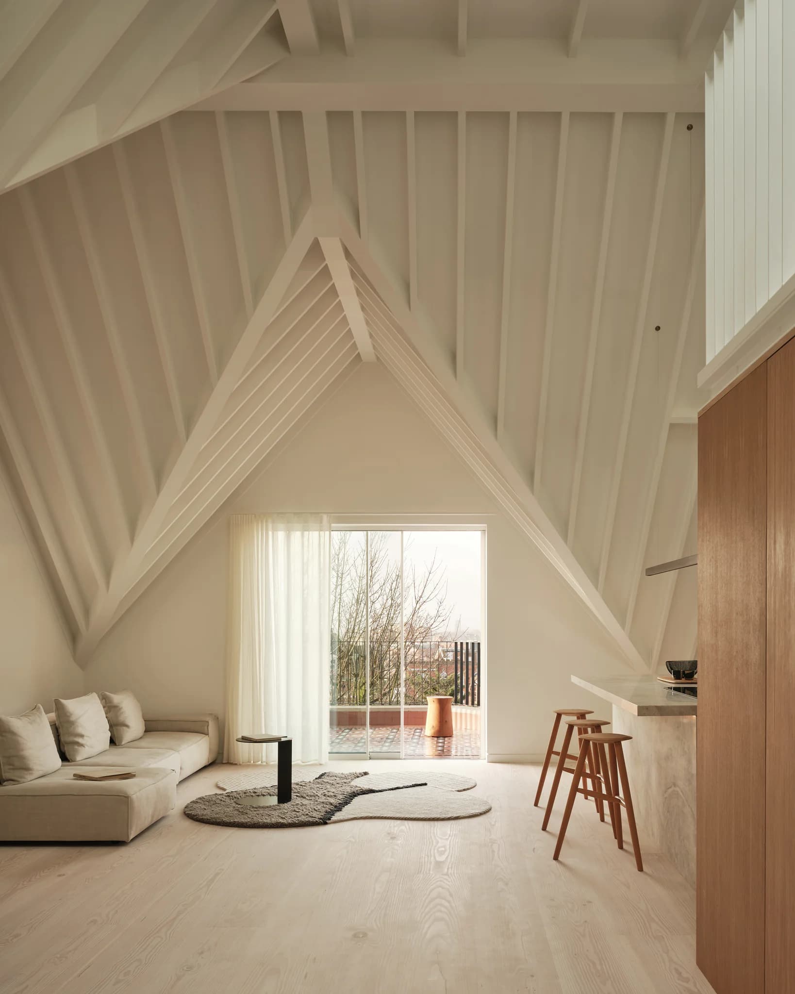 Vaulted home interior framed by slim aluminium glazing