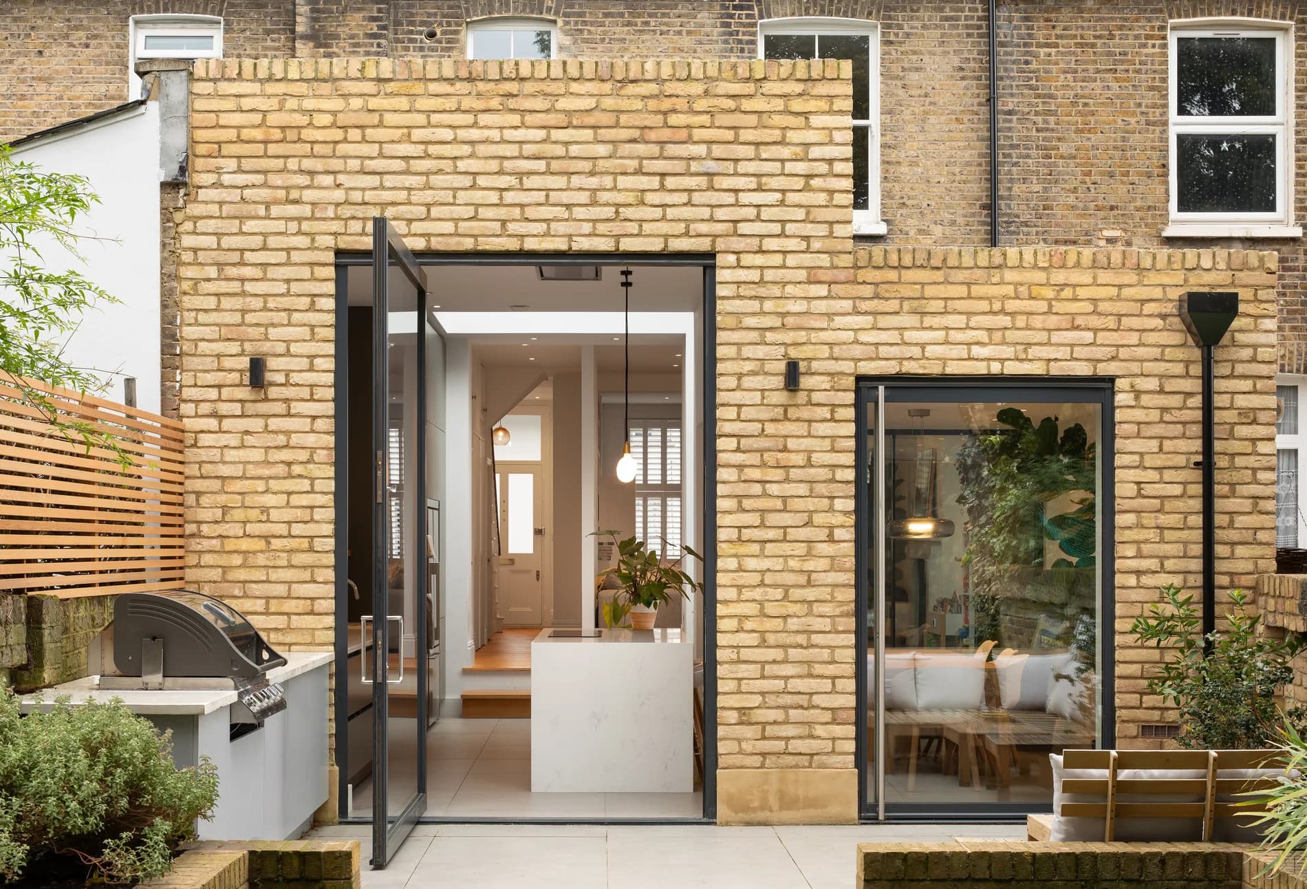 S-Max pivot doors on a brick rear elevation with the right-hand door clearly visible