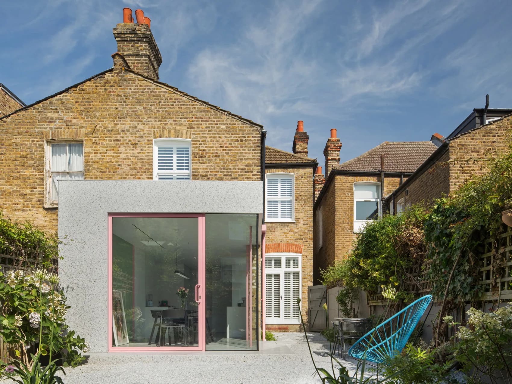 Pink F-Max pivot door within a contemporary rear extension