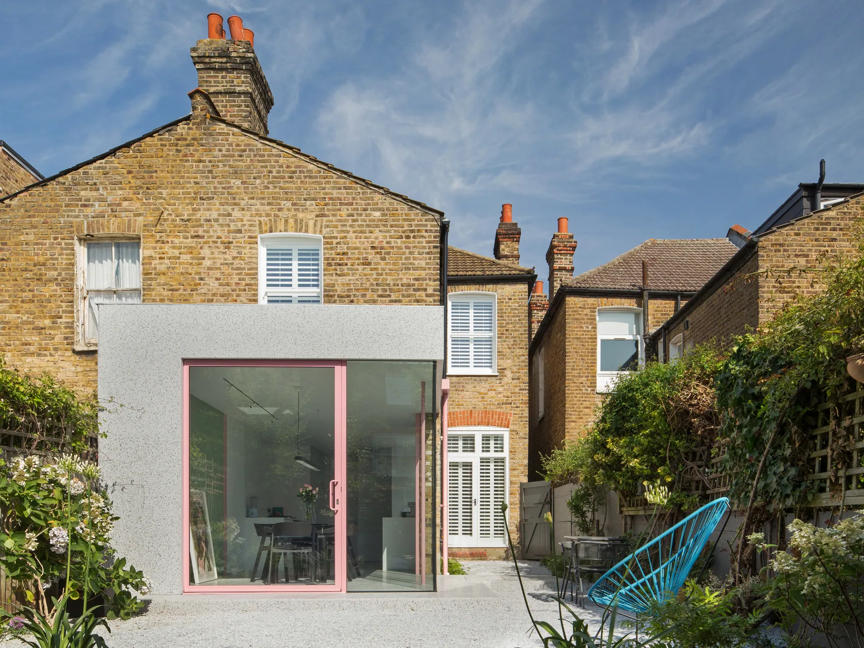 Pink F-Max pivot door within a contemporary rear extension