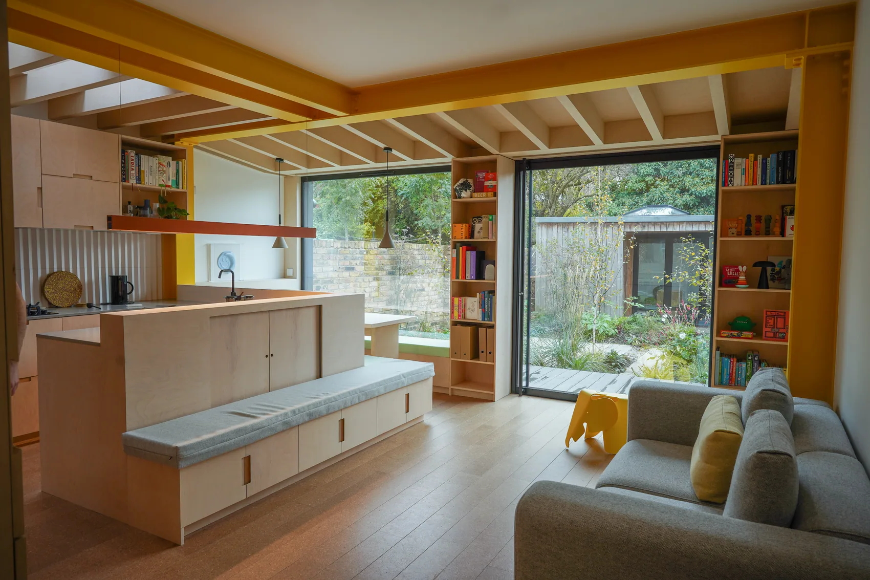 S-Max pivot door opening from a timber-lined living space to the garden