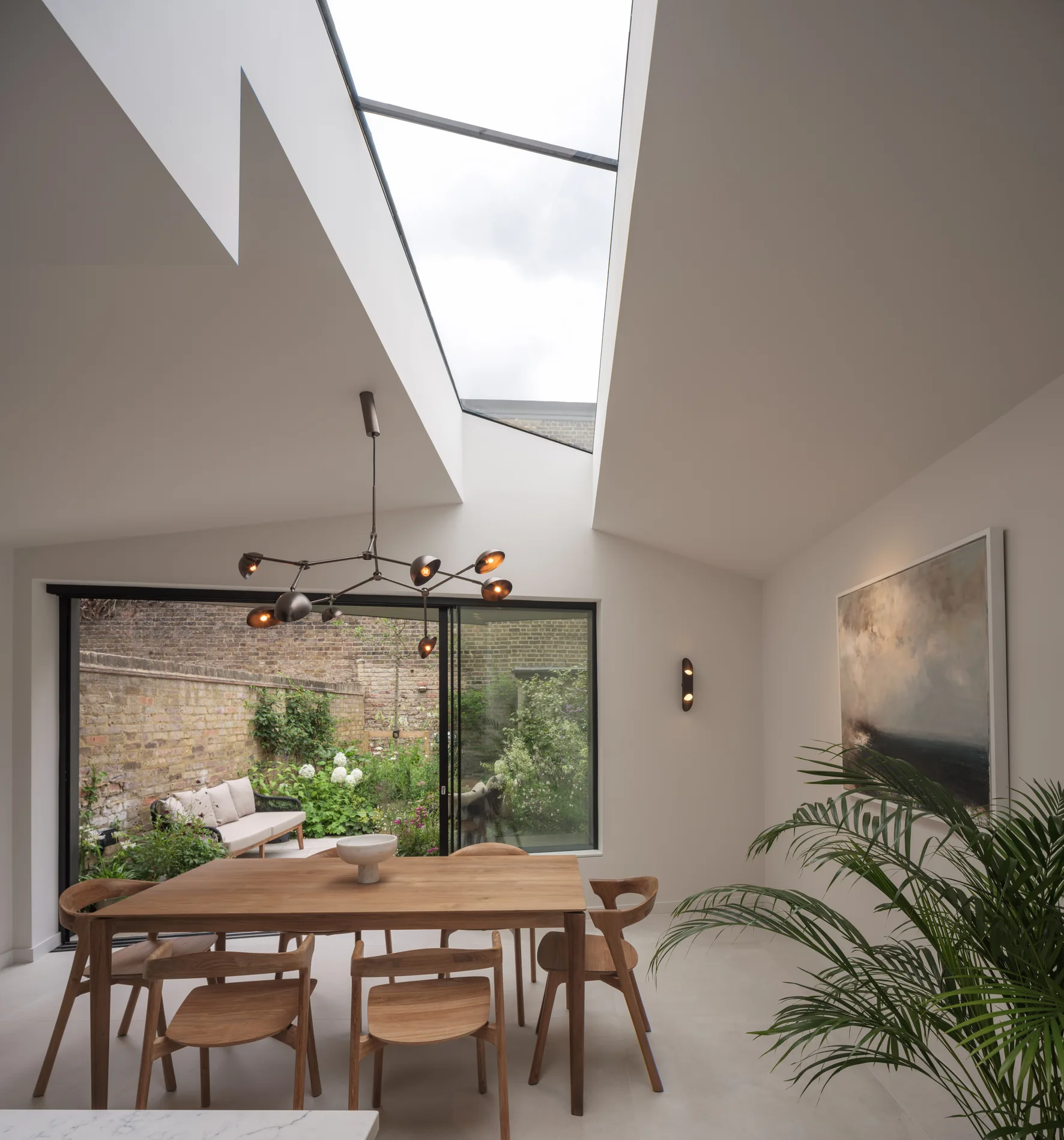Skymax rooflight above a dining space with exposed brick and garden doors