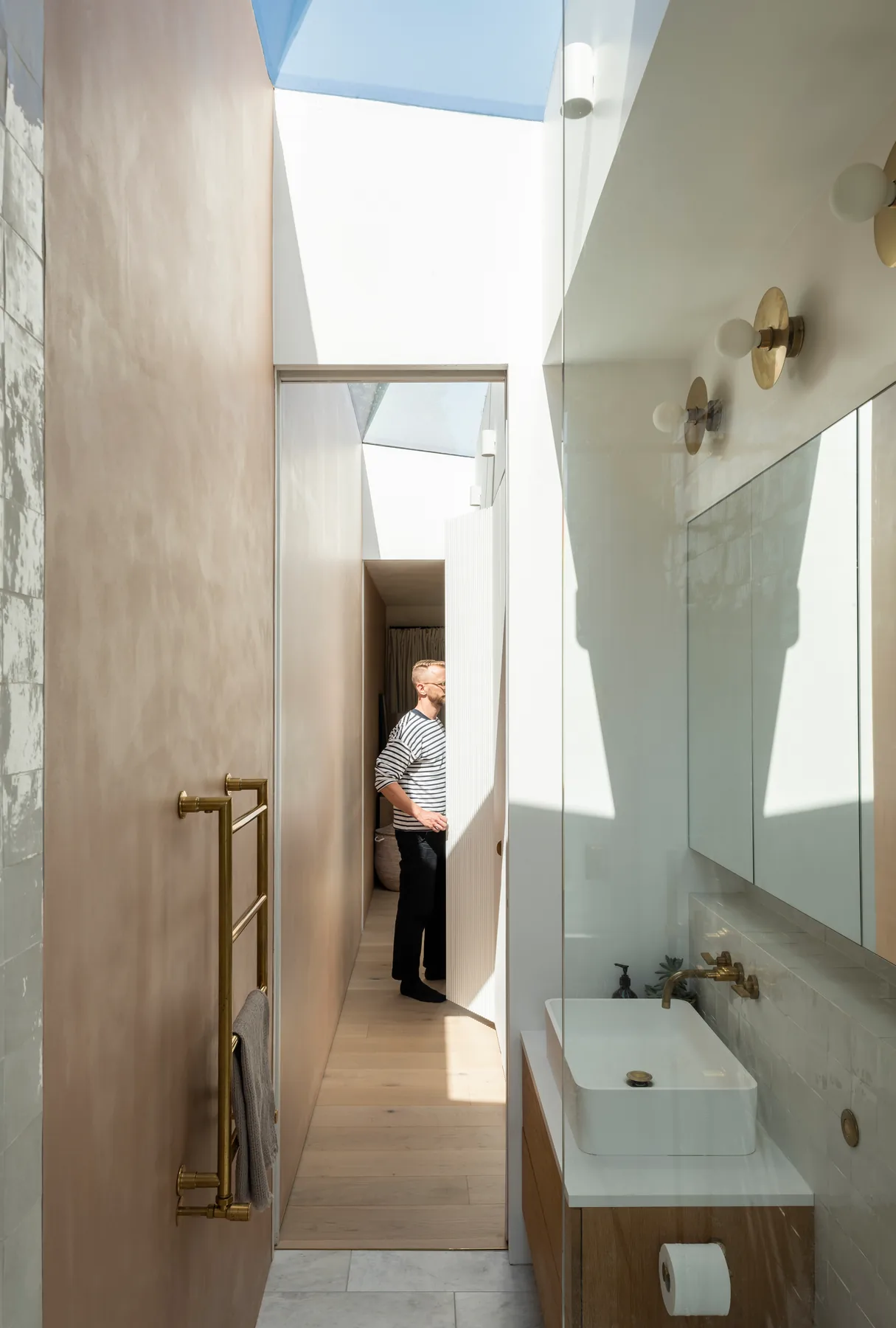 Bathroom vanity lit from above by a narrow Skymax rooflight