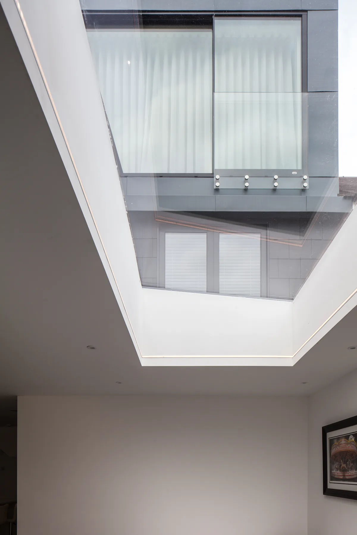 Rooflight well beside a courtyard-facing glazed wall