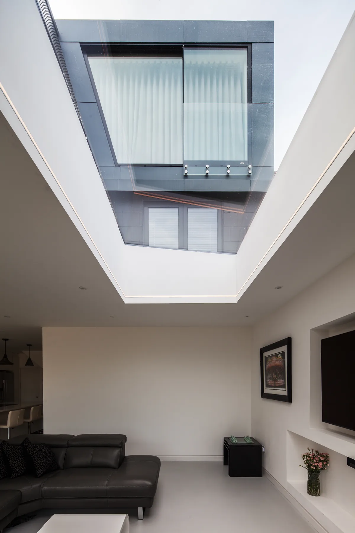 Living space with a large overhead Skymax rooflight and courtyard wall