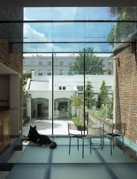 Maxlight aluminium rooflight with exposed steel beams over residential kitchen extension — structural overhead glazing engineered in London