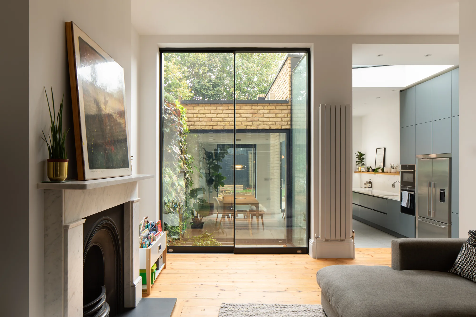 Two-panel aluminium sliding door connecting a living space with a garden extension