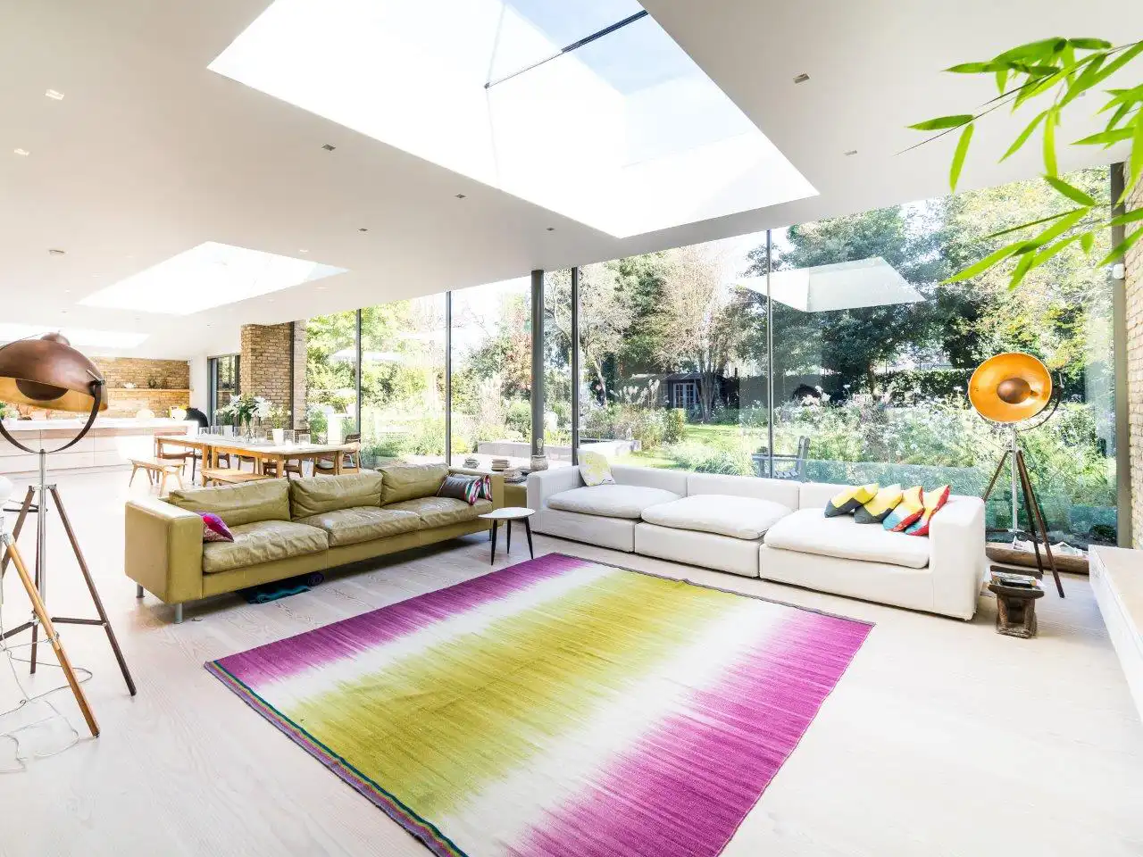 Bright open-plan living room with a multi-panel glazed garden elevation and rooflights