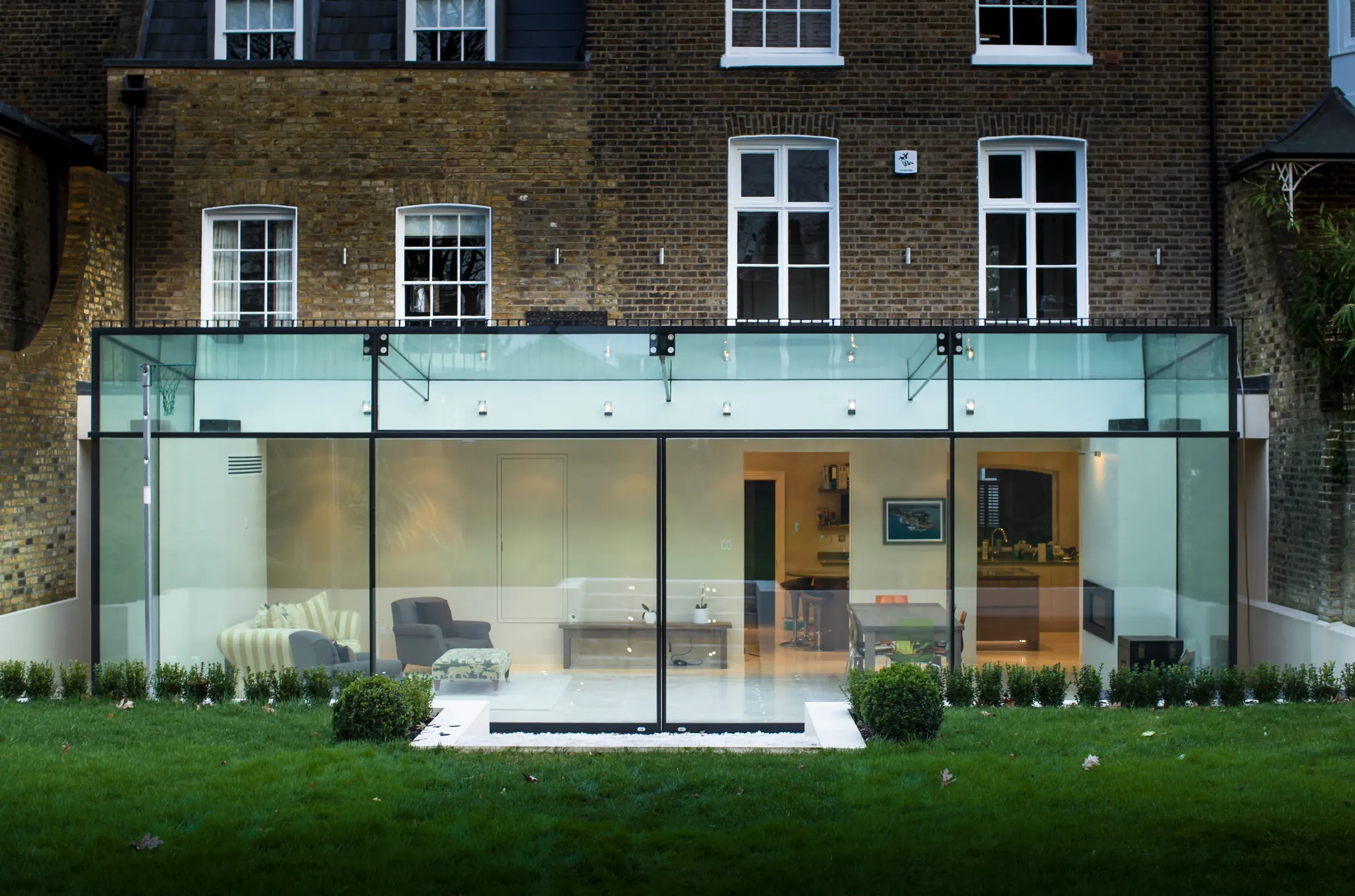 Glass box extension connecting kitchen and garden