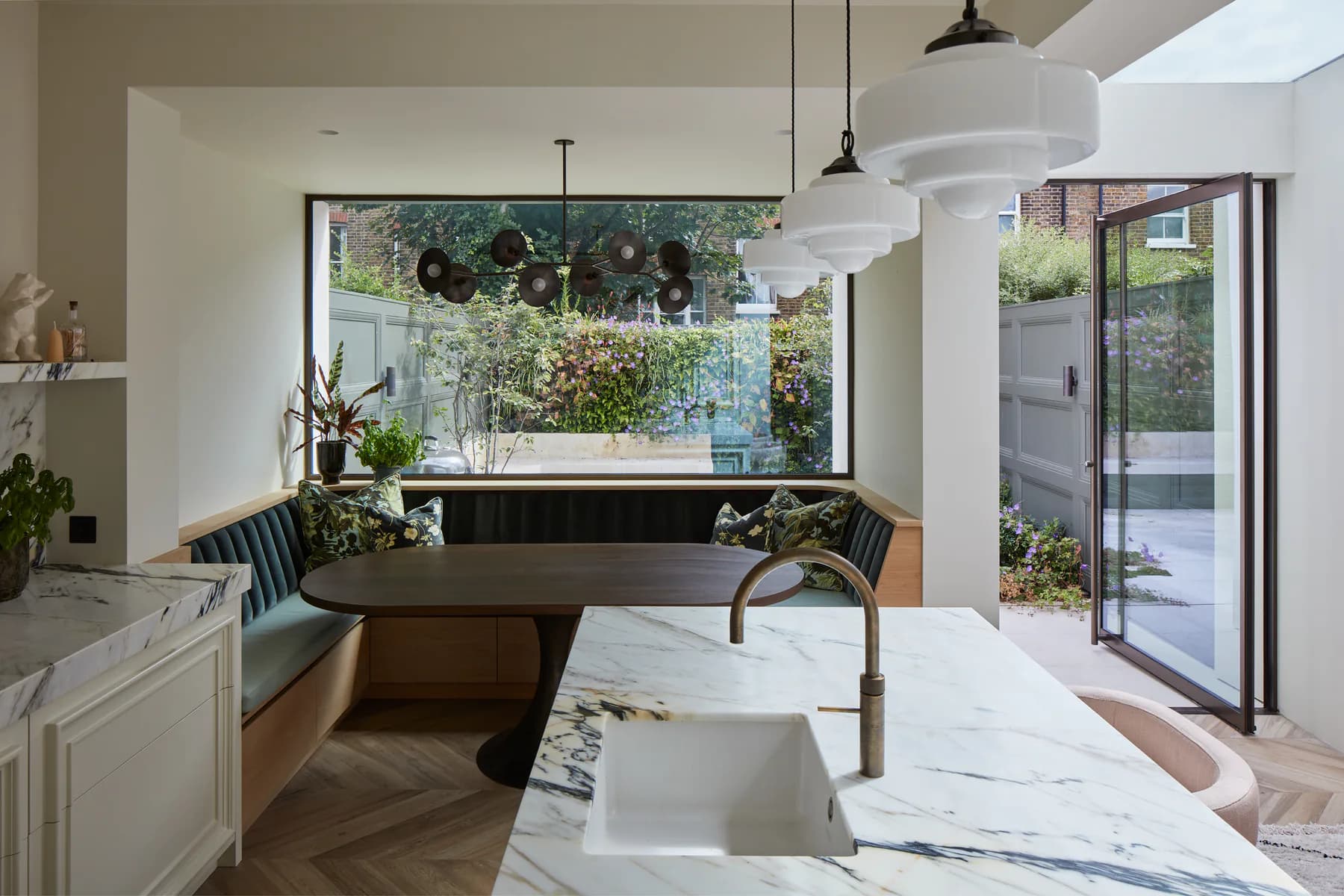 Wide fixed picture window framing planting from a bright kitchen island