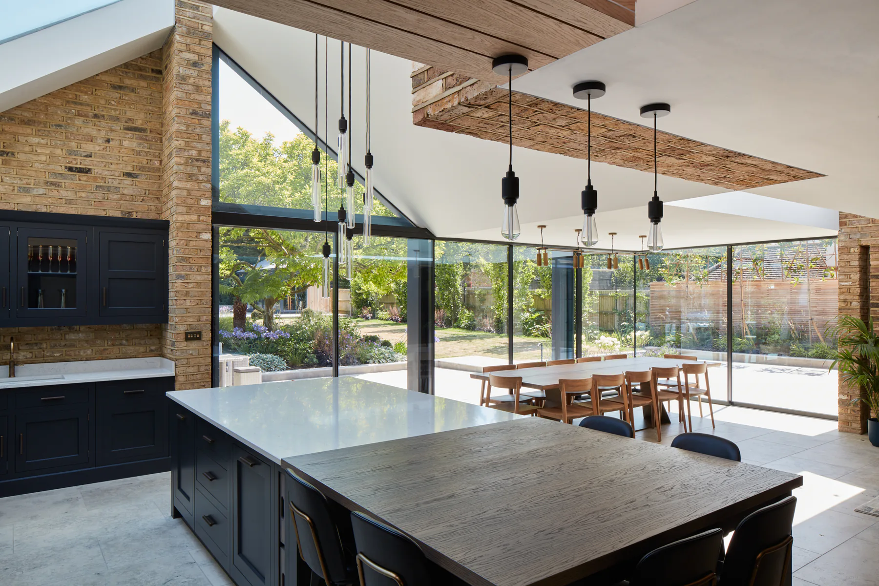 Fixed aluminium glazing bringing garden views into an open-plan kitchen