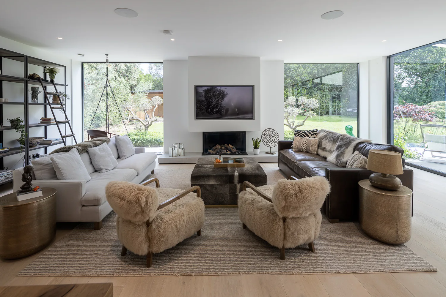 Fixed corner windows bringing garden views around a relaxed sitting room