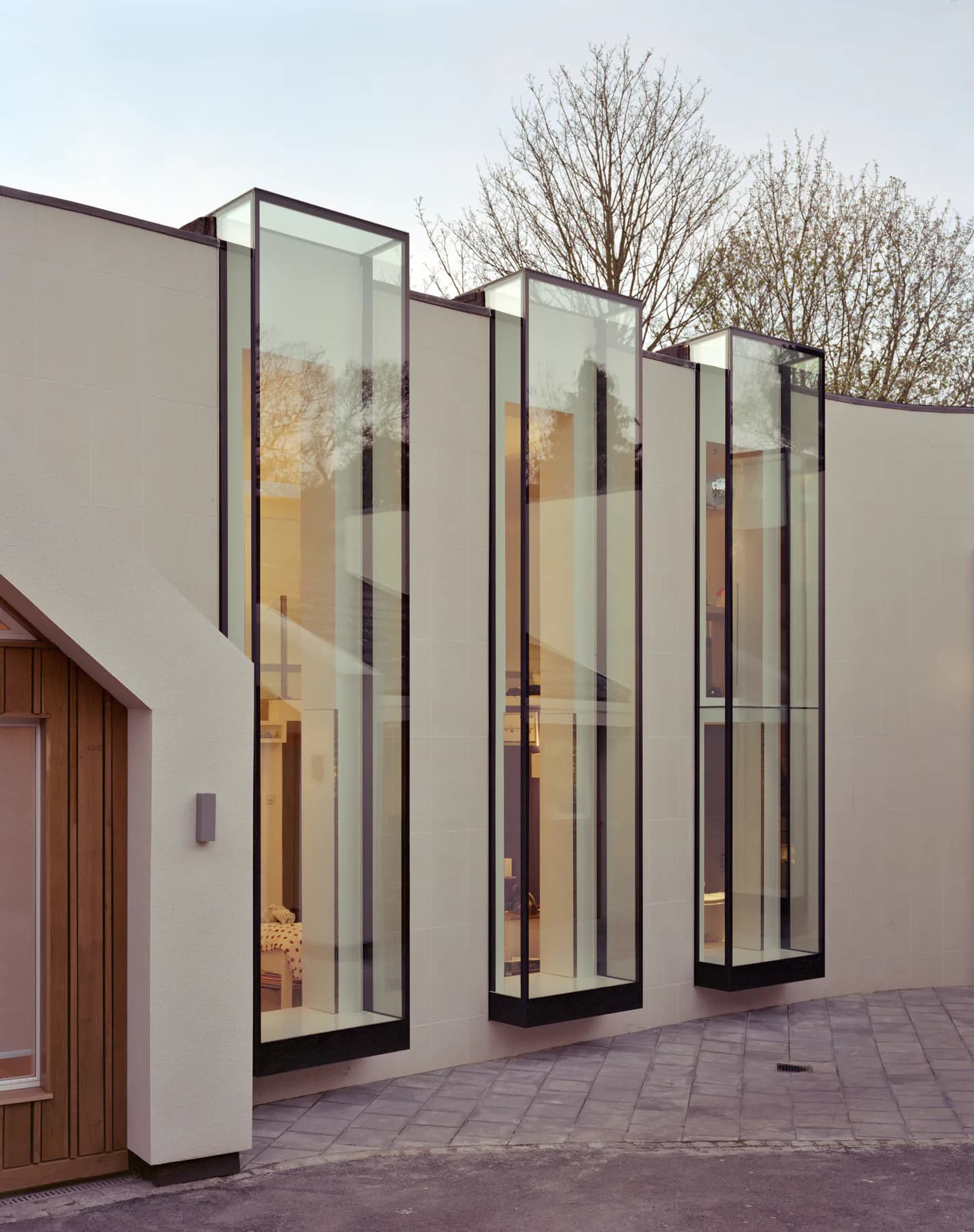 Exterior of a Maxlight Oriel Bay Window projecting from the building envelope with frameless glass-to-glass corners.